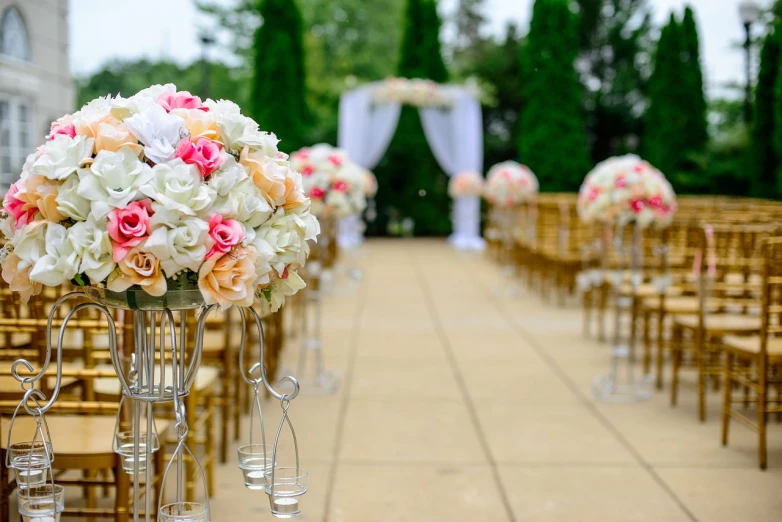 a row of chairs with vases filled with flowers, by John Murdoch, pexels, romanticism, with walkways, glittery wedding, pillar, full color