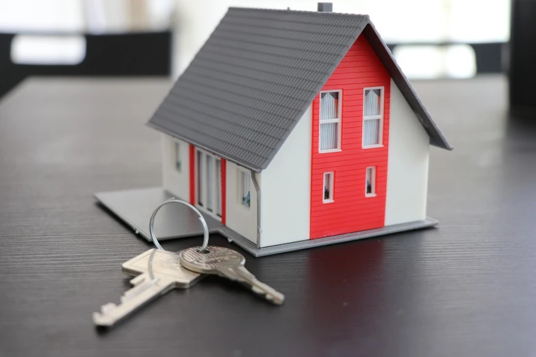 a toy house sitting on top of a table next to a bunch of keys, red white and black color scheme, listing image, finely detailed feature, single floor