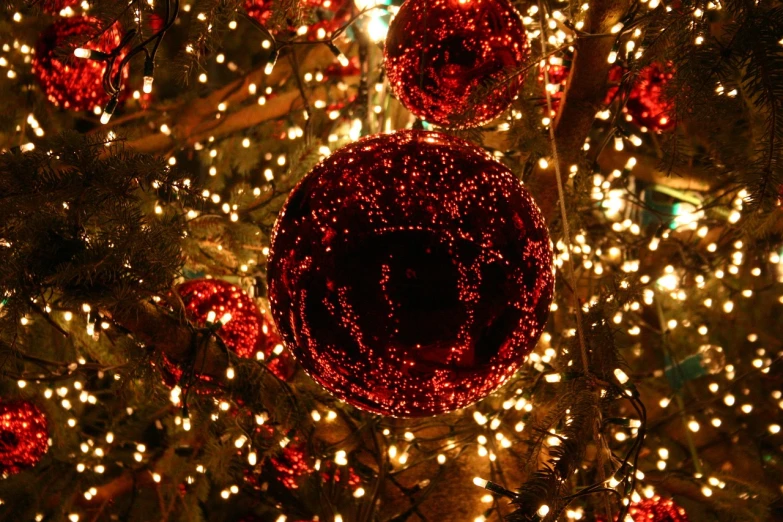 a close up of a red ornament on a christmas tree, by Aleksander Gierymski, arabesque, many glowing lights, shiny skin”, deep colours. ”