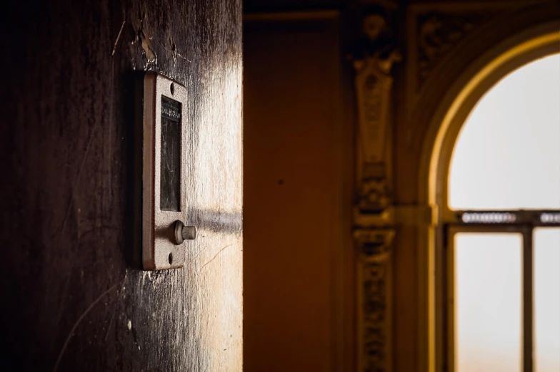 a close up of a door with a window in the background, by Matthias Weischer, baroque, dramatic golden light, switch, lost place photo, tactile buttons and lights