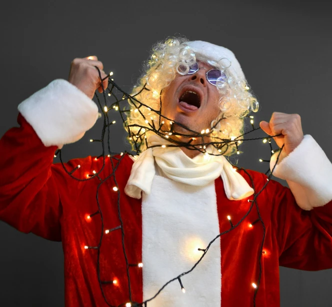 a man dressed as santa claus holding up christmas lights, incoherents, the man is screaming and sad, glowing thing wires, lowres, electrified hair