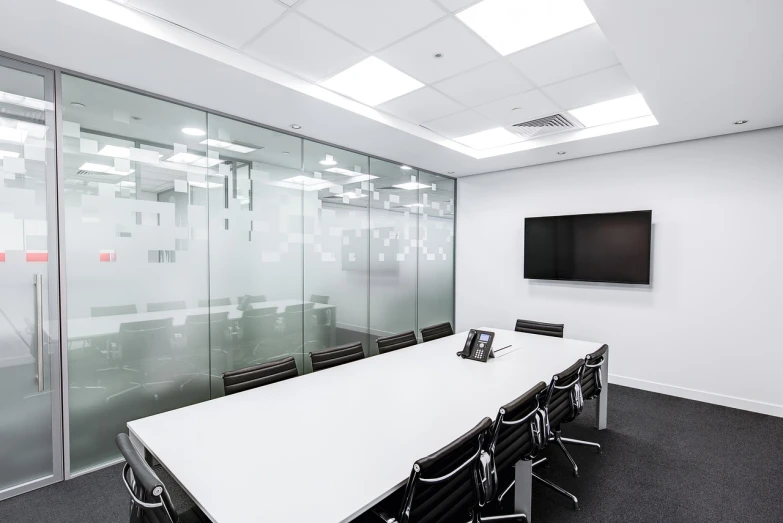 a conference room with a flat screen tv, by John Murdoch, pexels, bauhaus, fluorescent ceiling lights, clear glass wall, black on white, modern minimalist f 2 0 clean