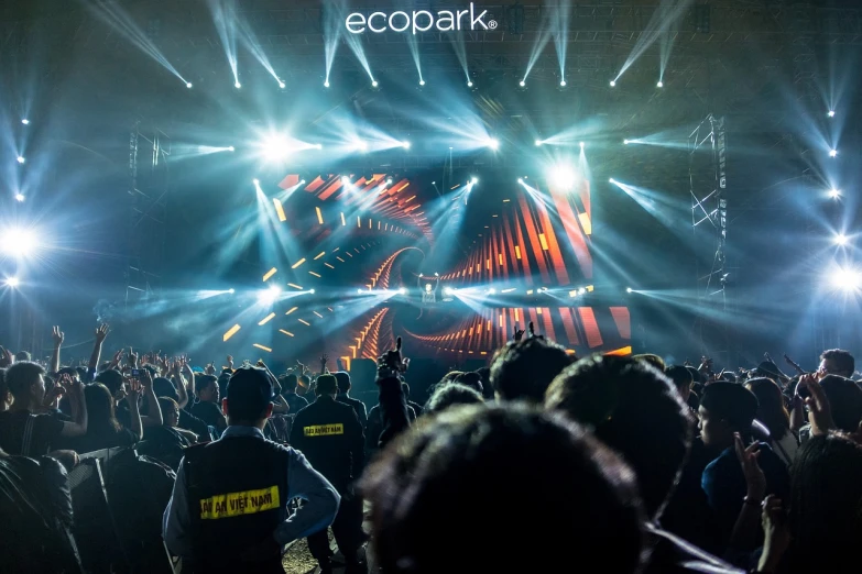 a crowd of people standing in front of a stage, by Giorgio Cavallon, unsplash contest winner, funk art, sangyeob park, epic stark lighting, eco, packshot