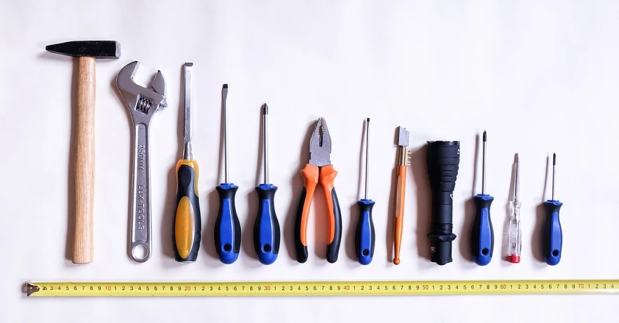 a group of tools sitting on top of a white surface, a stock photo, by Juan O'Gorman, pexels, hyperrealism, lined up horizontally, caretaker, full length photo, measurements