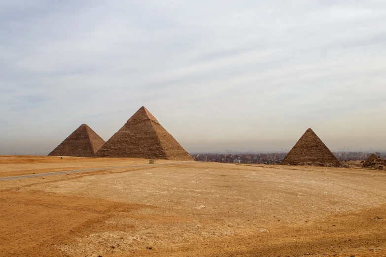 a group of three pyramids in the desert, wide shot photo, skyline showing, ancient egypt painting, 2 0 2 2 photo