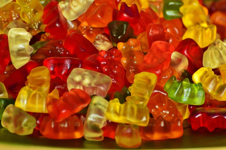 a bowl filled with lots of gummy bears, a picture, by Aleksander Gierymski, pexels, full of colour 8-w 1024, jelly - like texture, many teeth, italy