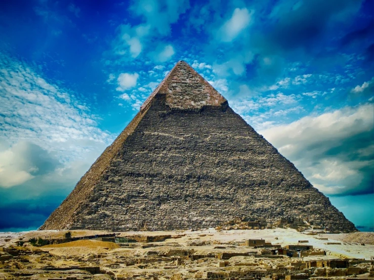 a very tall pyramid sitting in the middle of a desert, egyptian art, hdr photo, cinematic view from lower angle, under blue clouds, worked stone