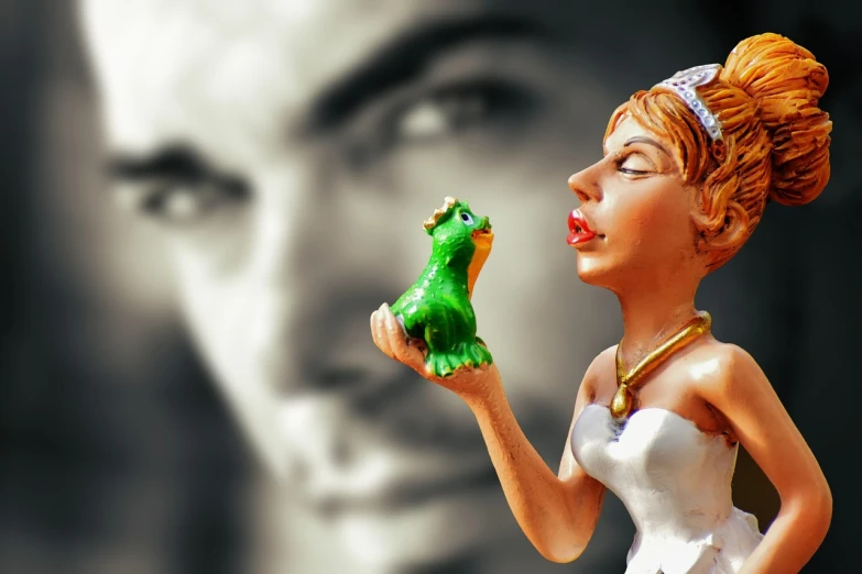 a close up of a figurine of a woman holding a frog, inspired by Jeff Koons, magic realism, princess in foreground, photo render, handsome man, watch photo