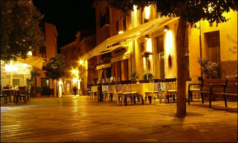 a street filled with lots of tables and chairs, a picture, by Antonio Saura, paisible night lighting, costa blanca, bizzaro, base