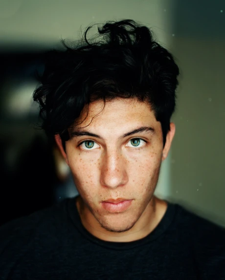 a close up of a person with freckles on their face, by Nathalie Rattner, he looks like tye sheridan, with black hair, green eyes!!!!, andrew gonzalez