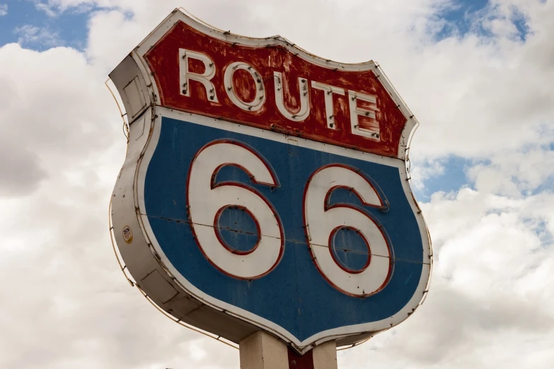 a route 66 sign with a cloudy sky in the background, flickr, closeup photo, high detail photo, reportage photo, 2 0 2 2 photo