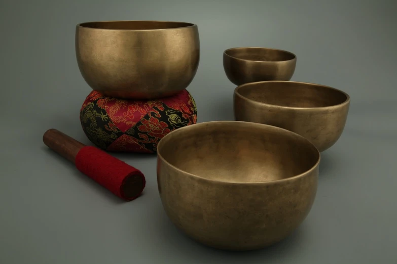 a group of singing bowls sitting on top of a table, trending on polycount, dau-al-set, c 4 d ”, hyperdetailed photorealism”