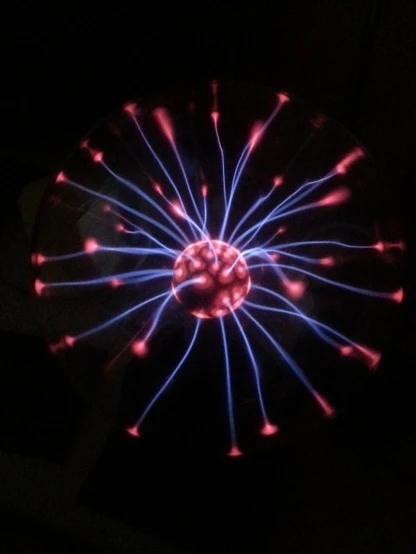a close up of a glowing object in the dark, a hologram, flickr, nuclear art, radiolaria, tesla coil, iphone photo, taken with canon eos 5 d
