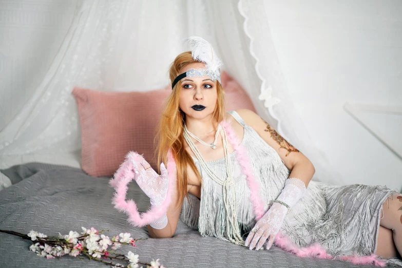 a woman in a silver dress laying on a bed, inspired by Gerda Wegener, art deco, young beautiful hippie girl, with pink hair, white long gloves, with long blond hair