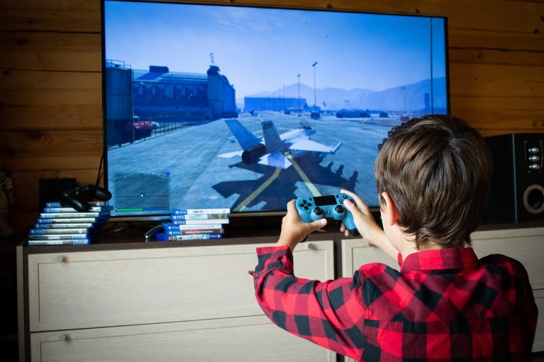 a young boy playing a video game on a flat screen tv, a stock photo, by Jakob Gauermann, shutterstock, gta v gameplay screenshot, ace combat, life simulator game screenshot, ps 4 screenshot