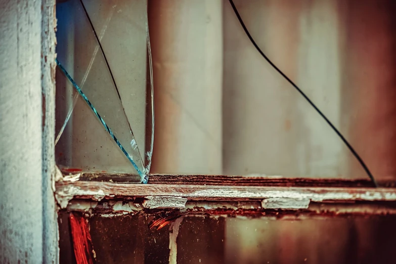 a close up of a window with a broken glass, a picture, by Elsa Bleda, pexels, visual art, scaffolding collapsing, overturned chalice, vivid lines, vintage color