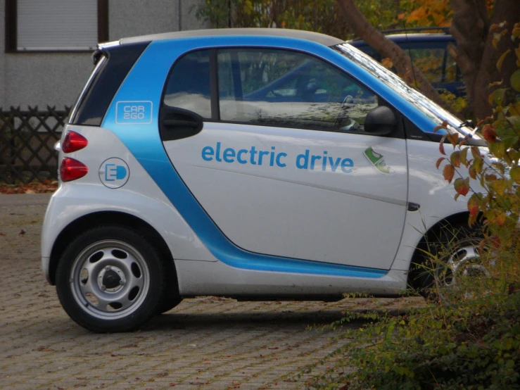 a small electric car parked on the side of the road, by Adam Marczyński, pixabay, les automatistes, square, 2013, prototype, pear