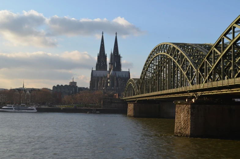 a bridge over a body of water with a cathedral in the background, a picture, by Robert Zünd, photo taken in 2018, karl heilmayer, two towers, wikimedia