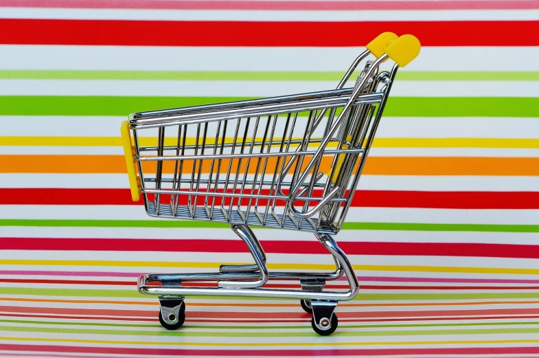 a shopping cart sitting on top of a striped surface, maximalism, shiny colors, seventies, wallpaper!, yummy