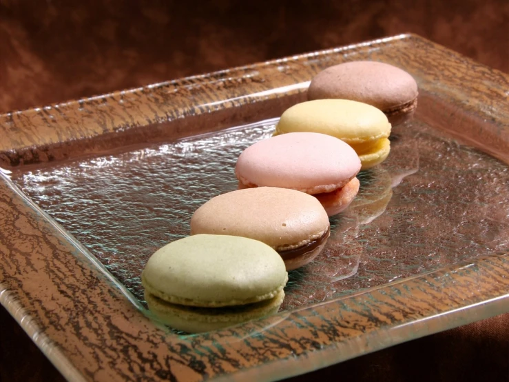 a group of macarons sitting on top of a glass plate, a pastel, inspired by Charles Le Roux, flickr, renaissance, koji morimoto shinjuku, afp, stained”, glaze