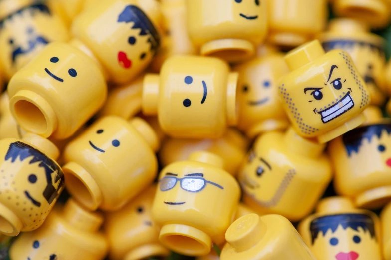 a pile of yellow lego minifigs with faces on them, a picture, 8 0 mm photo, focus on facial features, 4k photo”