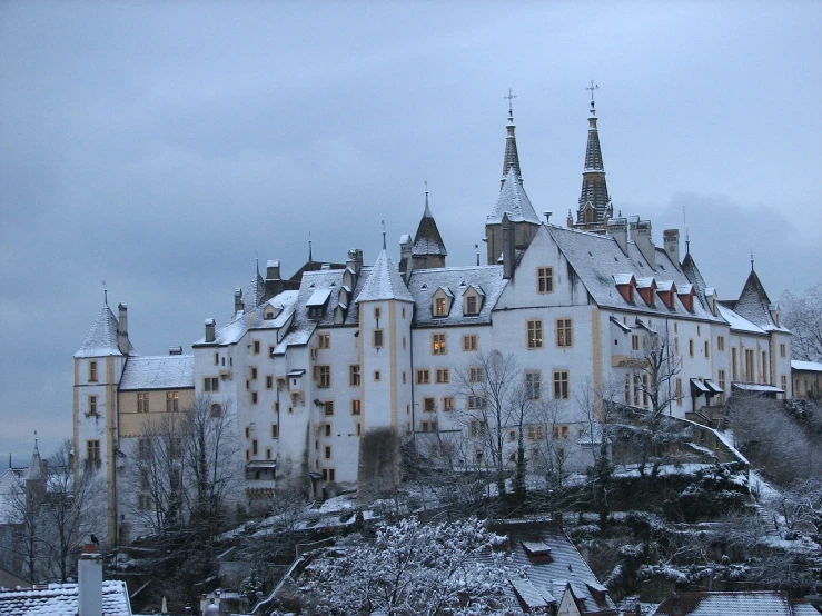 a castle sitting on top of a snow covered hill, by Werner Gutzeit, flickr, white houses, wintry rumpelstiltskin, cloissonne, college