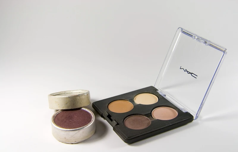 a couple of eyeshadows sitting on top of a table, a picture, inspired by Mac Conner, flickr, product introduction photo, 4 0 9 6, grunged up, set against a white background