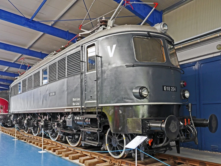 a train that is sitting on some tracks, a portrait, by Joseph von Führich, shutterstock, bauhaus, electric motors, displayed in a museum, steel gray body, fully functional