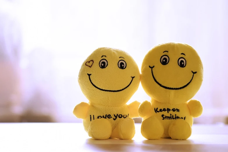a couple of smiley faces sitting next to each other, a picture, romanticism, plush doll, yellow, picture, sweet