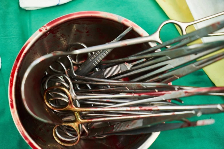 a bowl full of scissors sitting on top of a table, by Bernard Meninsky, shutterstock, vanitas, medical dissection, instagram photo, with organs, partially operational