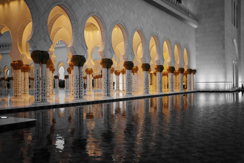 a black and white photo of the inside of a building, inspired by Alberto Morrocco, shutterstock, arabesque, golden-white robes, reflective water, color and contrast corrected, arabia