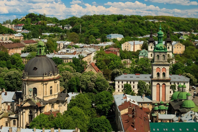 a view of a city from the top of a hill, by Aleksander Gierymski, shutterstock, lviv historic centre, ultrawide angle cinematic view, green, khreschatyk