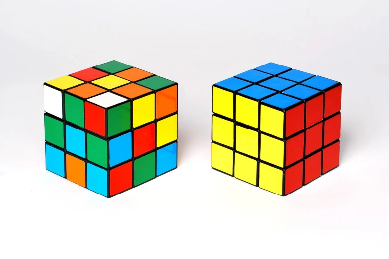 a couple of rubik cubes sitting next to each other, inspired by Ernő Rubik, pixabay, cubo-futurism, front and side views, high color contrast, solid cube of light, 2 - bit