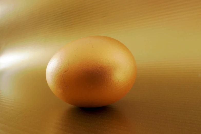 a golden egg sitting on top of a table, a picture, 4k high res, 3 4 5 3 1
