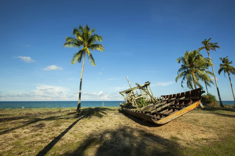 a boat sitting on top of a grass covered field, a stock photo, shutterstock, visual art, dried palmtrees, sunken ship, in a beachfront environment, hawaii