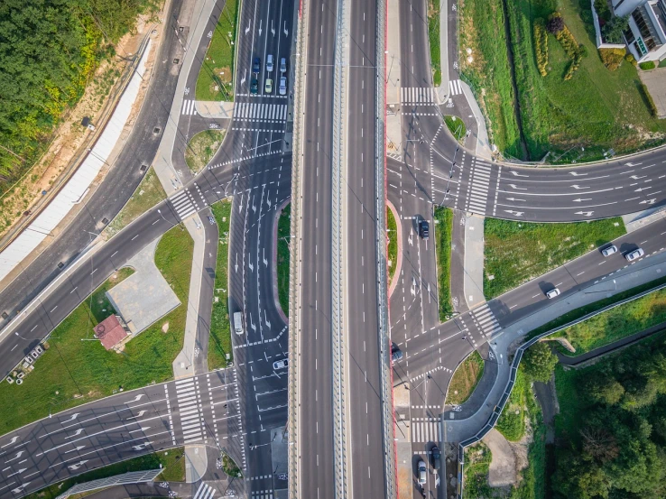 an aerial view of a busy highway intersection, a picture, by Adam Marczyński, shutterstock, realism, high angle uhd 8 k, symmetrical detail, bridges crossing the gap, detailed zoom photo