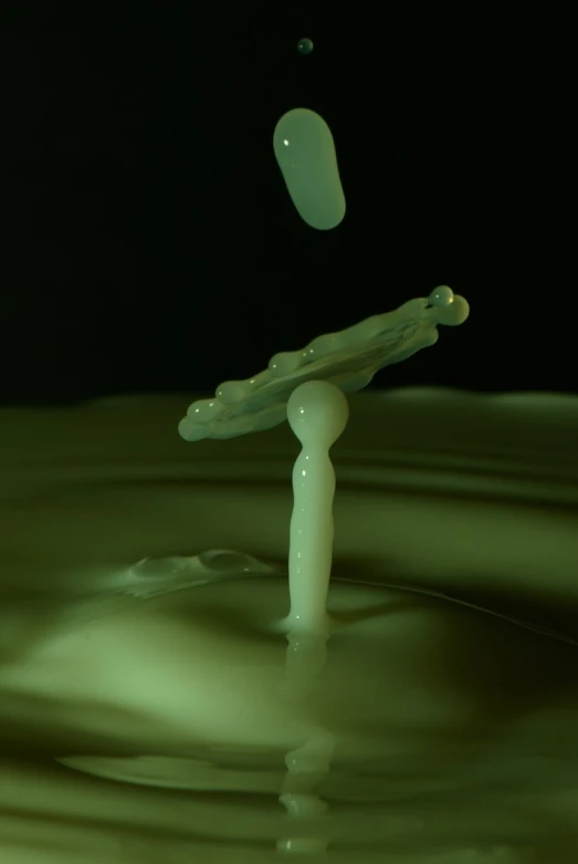 a drop of milk is falling into the water, a microscopic photo, inspired by Lucio Fontana, polycount, glow in the dark, jumping towards viewer, stopmotion, liquid sculpture