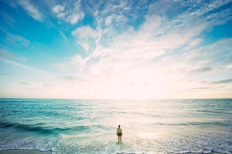 a person standing in the water at the beach, shutterstock, minimalism, wide angle full body, summer morning light, an astronaut lost in the ocean, professionally color graded