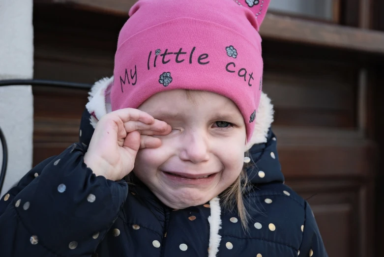 a little girl that is wearing a pink hat, a photo, by Anita Malfatti, pixabay, putin crying, happy cat, beanie, humans of new york style