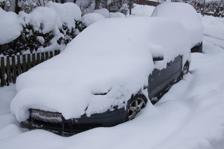 a car covered in snow next to a fence, flickr, auto-destructive art, from wheaton illinois, full body shot, unedited, front