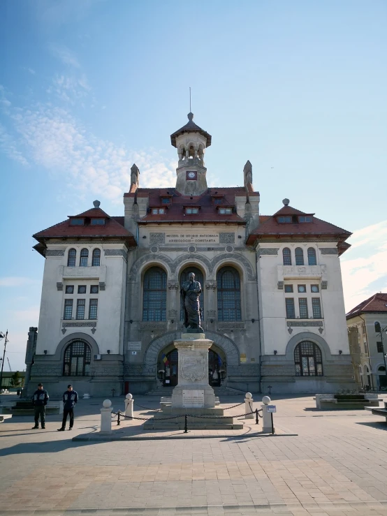a large building with a statue in front of it, a portrait, inspired by Balázs Diószegi, art nouveau, official courthouse, scenic full shot, tourist destination, otjize