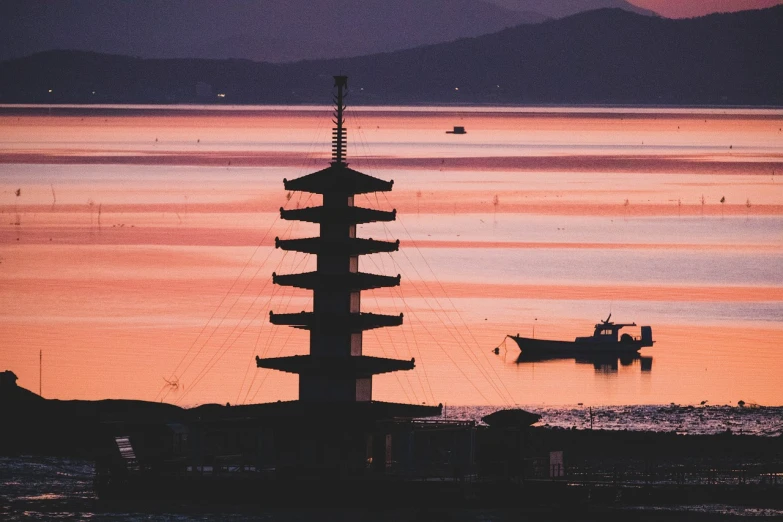 a tall tower sitting in the middle of a body of water, inspired by Itō Jakuchū, unsplash, the colours of the sunset, seaview, terminal, split near the left