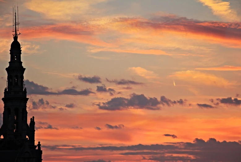 a clock tower with a sunset in the background, a photo, inspired by Frederic Edwin Church, romanticism, comet, photo taken from far away, altostratus clouds, telephoto shot