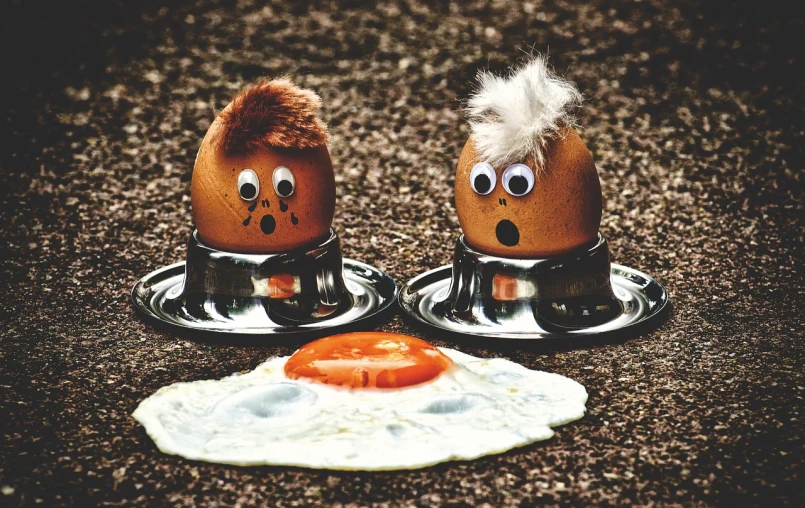 a couple of eggs sitting next to each other, a cartoon, by Georgina Hunt, trending on pixabay, happening, food photo, 🦩🪐🐞👩🏻🦳, drooling ferrofluid, coneheads