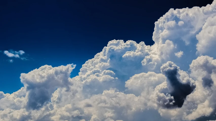 a jetliner flying through a cloudy blue sky, a picture, by Jan Rustem, towering cumulonimbus clouds, phone wallpaper hd, cumulus cloud tattoos, whorl. clouds