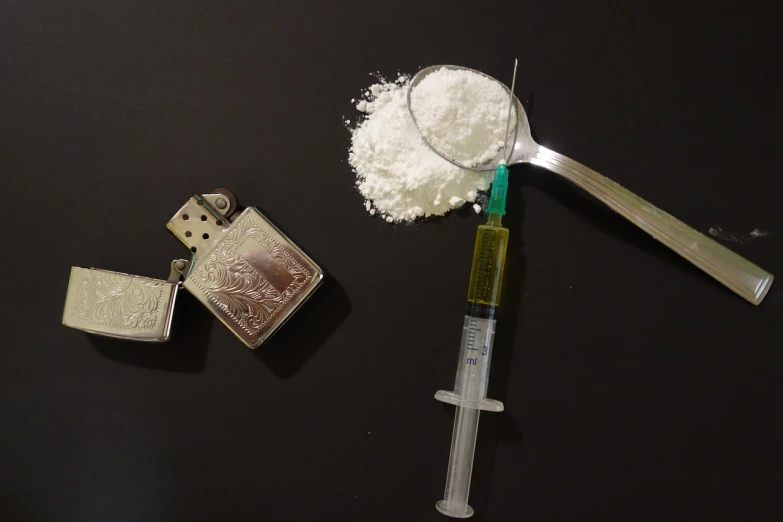 a couple of lighters sitting on top of a table, a still life, inspired by Joseph Delaney, pixabay, plasticien, white powder bricks, holding a syringe, spoon, high angle close up shot