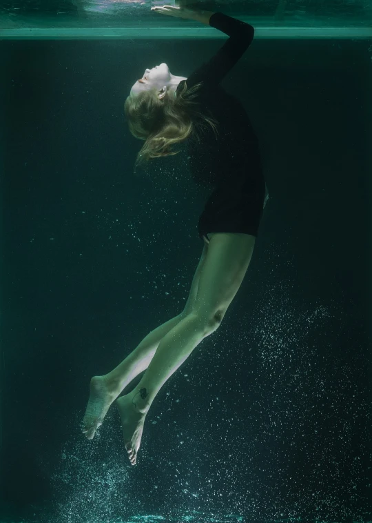 a woman floating in the water in a black leo leo leo leo leo leo leo leo leo leo leo leo leo leo leo leo, inspired by Brooke Shaden, todd hido, green water, beth cavener, joseph todorovitch ”