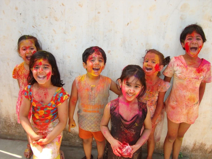 a group of young girls standing next to each other, flickr, action painting, festive colors, india, a still of a happy, covered in white flour