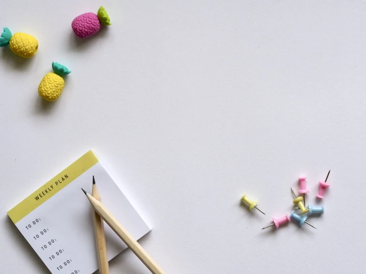 a notepad sitting on top of a table next to a pencil, unsplash, minimalism, candy decorations, background image, tiny sticks, cad