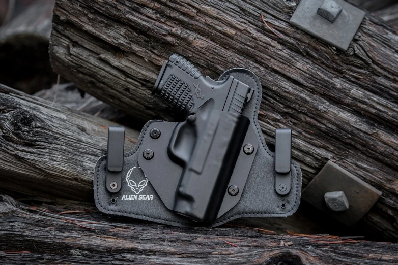 a black holster sitting on top of a pile of wood, a portrait, trending on polycount, highly detailed product photo, black swan, closeup photo, full subject shown in photo